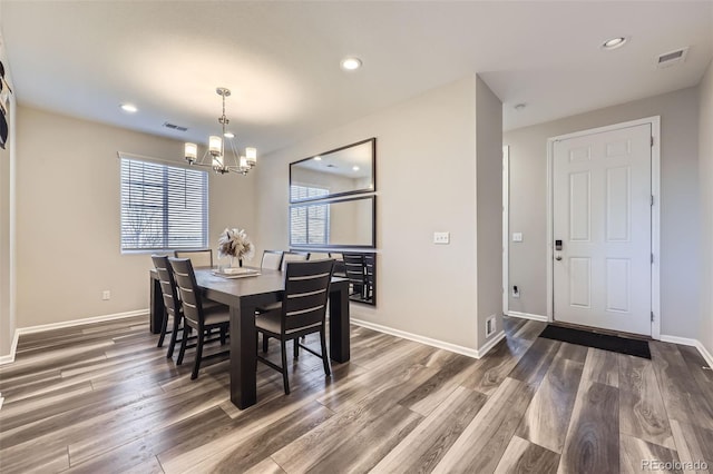 dining area featuring visible vents, plenty of natural light, and wood finished floors