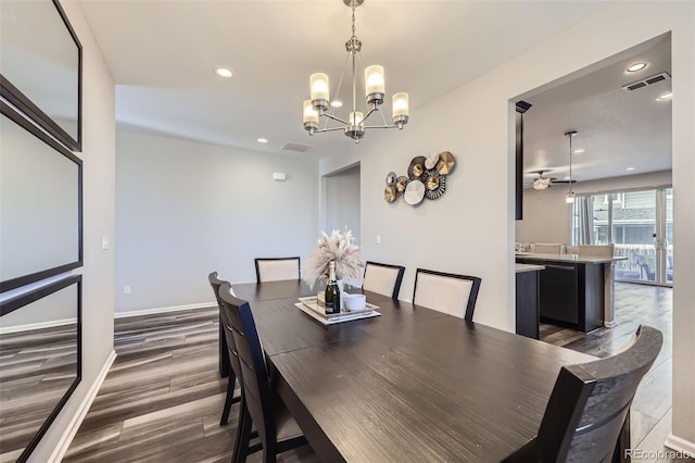 dining area featuring recessed lighting, ceiling fan with notable chandelier, dark wood-style flooring, visible vents, and baseboards