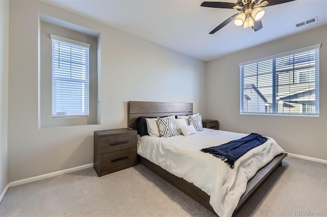 bedroom featuring light carpet, baseboards, visible vents, and ceiling fan