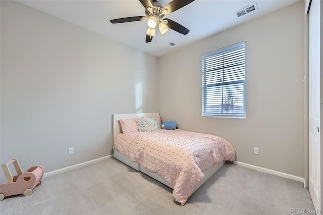 carpeted bedroom with ceiling fan, visible vents, and baseboards