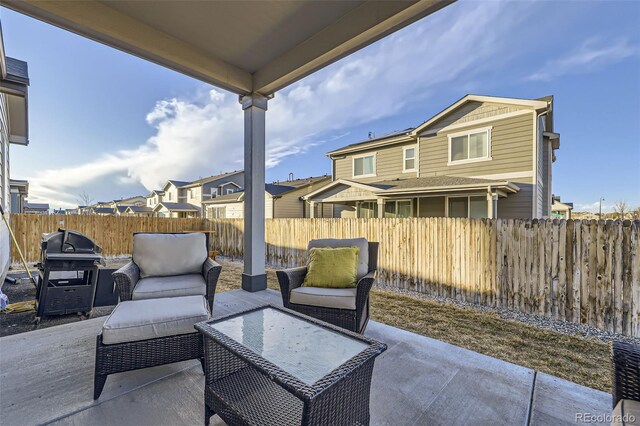 view of patio with a residential view, a grill, and fence