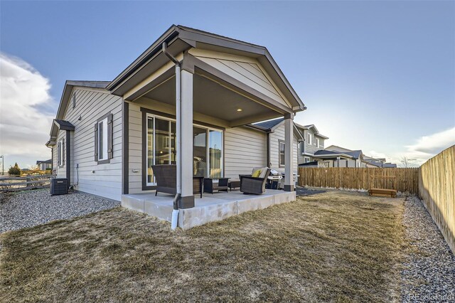 back of house featuring a patio area, a fenced backyard, and central air condition unit