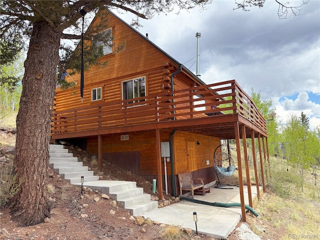 179 Mountain Vis, Como, CO 80432 - back of property featuring a deck, log siding, stairs, and a patio area