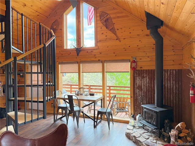 179 Mountain Vis, Como, CO 80432 - dining space with a wood stove, wooden walls, wooden ceiling, wood finished floors, and high vaulted ceiling