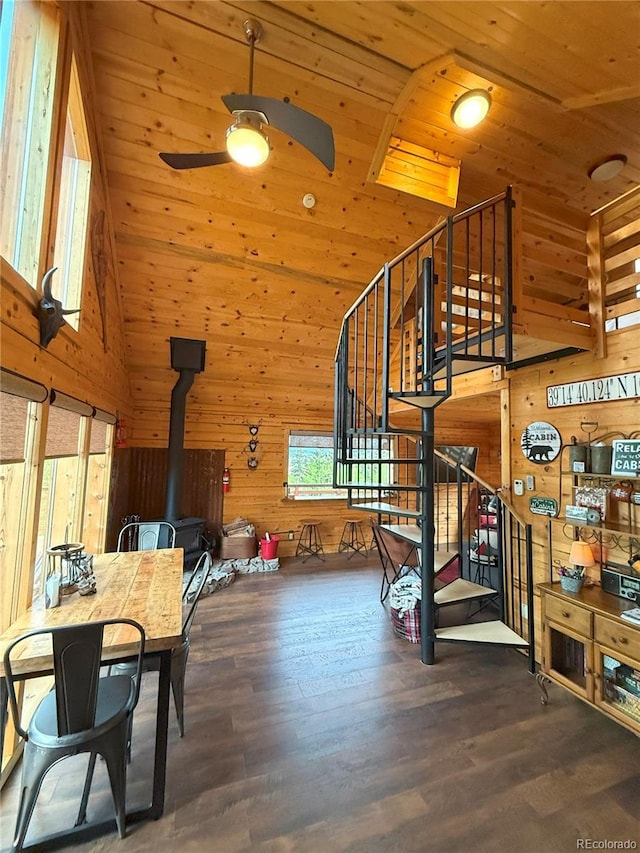 179 Mountain Vis, Como, CO 80432 - dining area with a wood stove, wooden walls, high vaulted ceiling, ceiling fan, and wood finished floors