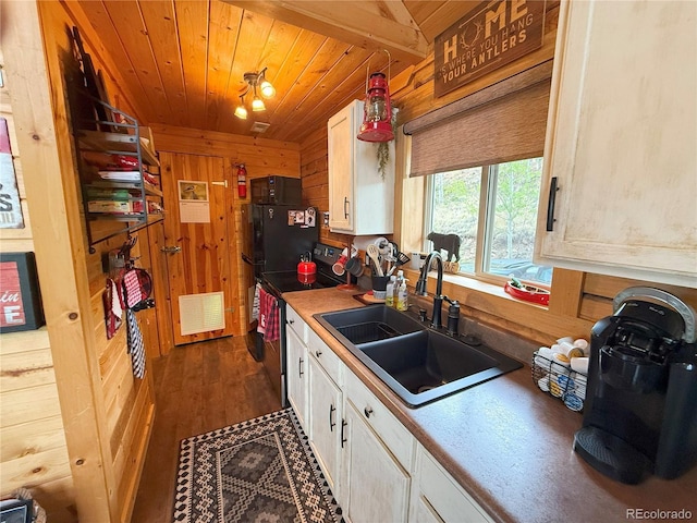 179 Mountain Vis, Como, CO 80432 - kitchen featuring a sink, white cabinets, wooden walls, wooden ceiling, and dark wood-type flooring