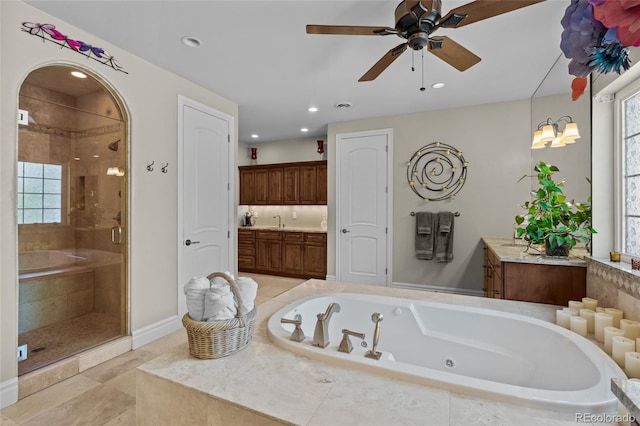 1160 Monaco Pkwy, Denver, CO 80220 - bathroom with a shower stall, vanity, a tub with jets, a ceiling fan, and recessed lighting