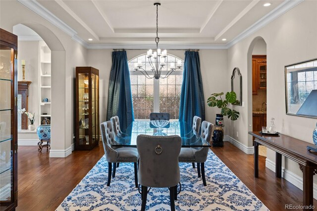 1160 Monaco Pkwy, Denver, CO 80220 - dining room with a chandelier, arched walkways, dark wood finished floors, a raised ceiling, and recessed lighting