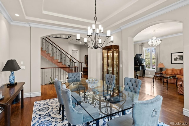 1160 Monaco Pkwy, Denver, CO 80220 - dining room featuring arched walkways, a chandelier, wood finished floors, crown molding, and recessed lighting