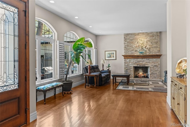 1160 Monaco Pkwy, Denver, CO 80220 - foyer with wood finished floors, a stone fireplace, and recessed lighting