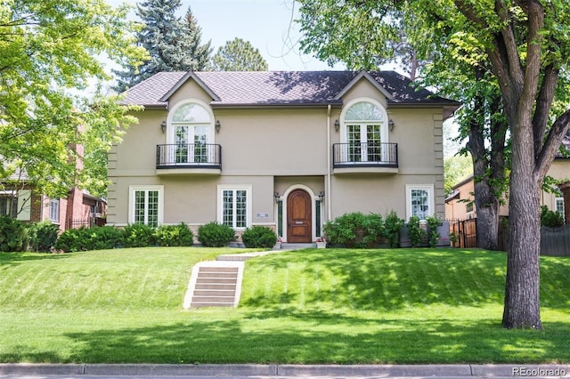1160 Monaco Pkwy, Denver, CO 80220 - view of front of house with a balcony, stucco siding, and french doors