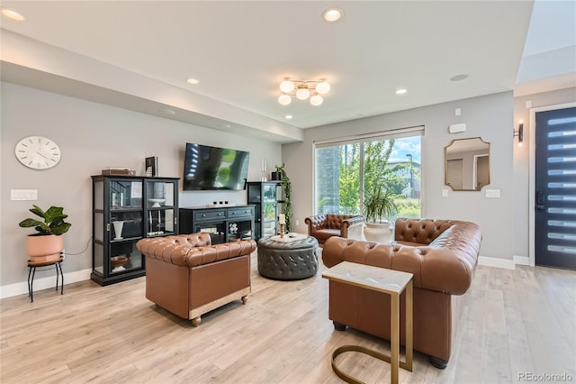 living room with light wood-type flooring, baseboards, and recessed lighting