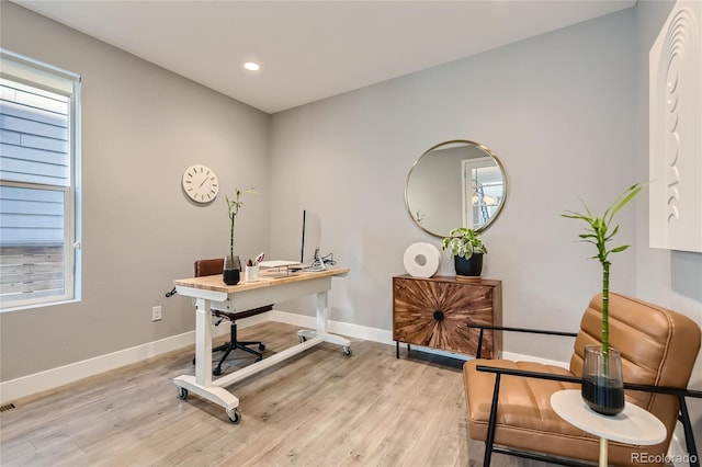 office space featuring light wood finished floors, recessed lighting, and baseboards