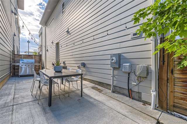 view of patio with outdoor dining area and a grill