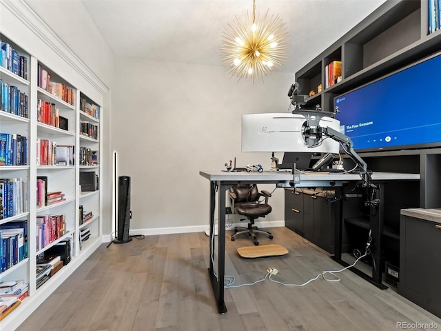 office area featuring wood finished floors, baseboards, and a chandelier