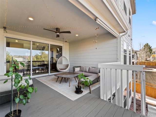 wooden deck with outdoor dining space, an outdoor hangout area, and a ceiling fan