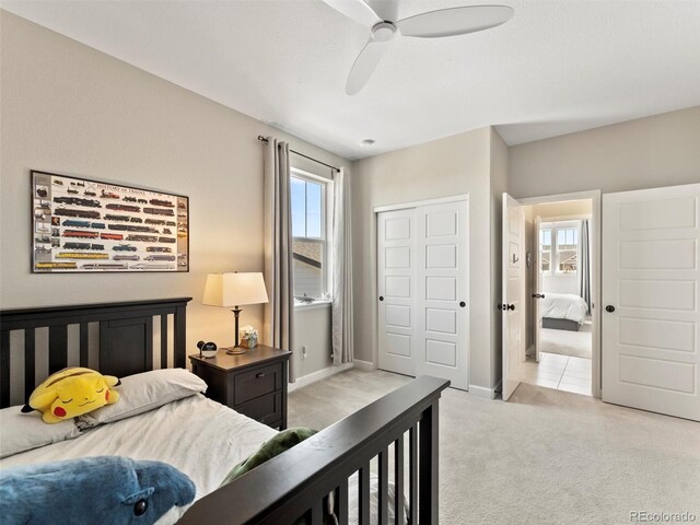 bedroom featuring baseboards, a closet, carpet floors, and ceiling fan