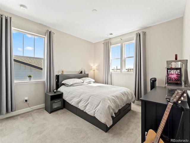 bedroom featuring light carpet, visible vents, and baseboards