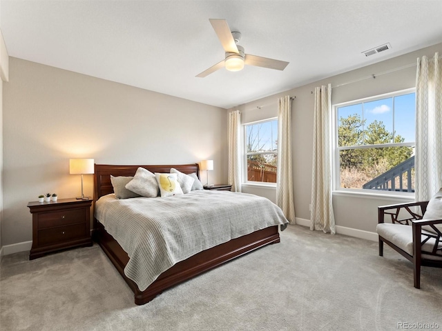 bedroom featuring light carpet, visible vents, a ceiling fan, and baseboards