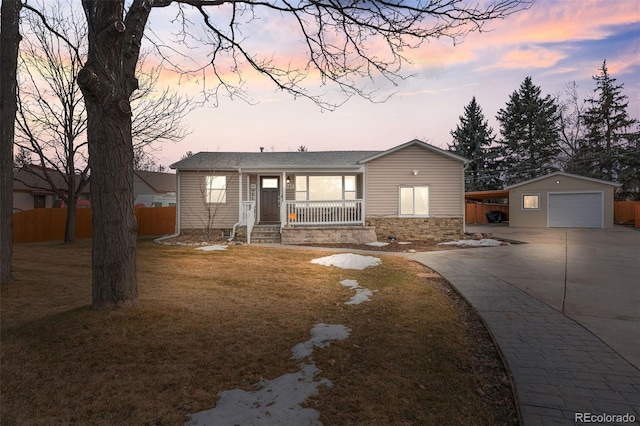 ranch-style home with covered porch, fence, a garage, stone siding, and an outdoor structure