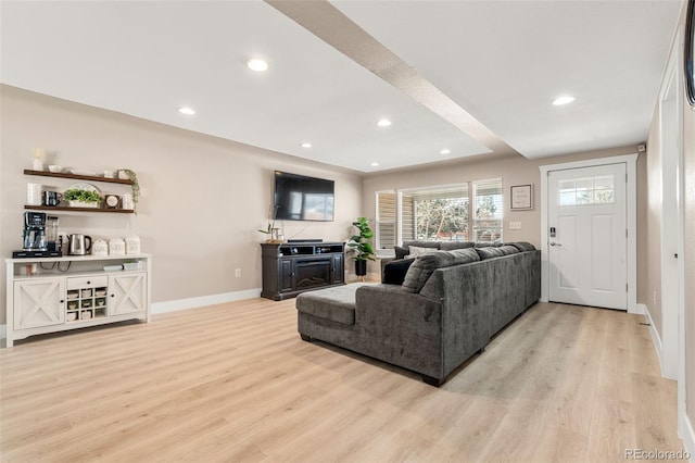 living area with light wood finished floors, baseboards, and recessed lighting