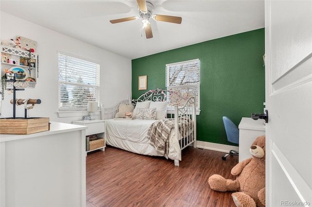 bedroom with ceiling fan, wood finished floors, and baseboards