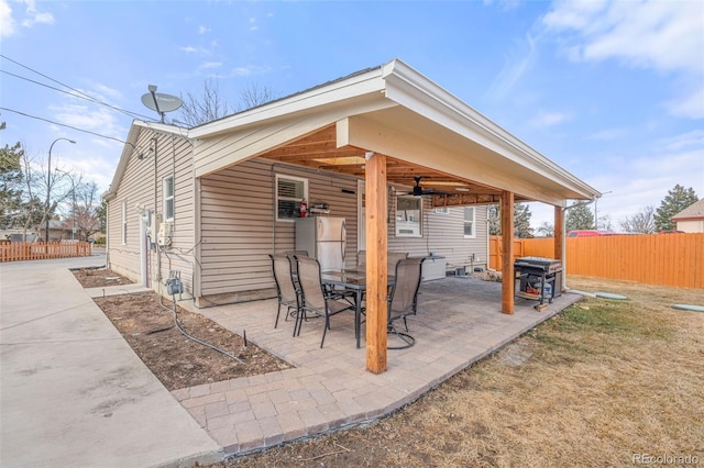 view of patio featuring fence and a ceiling fan