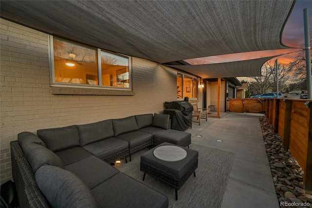 2544 S Raleigh St, Denver, CO 80219 - patio terrace at dusk with grilling area, fence, and outdoor lounge area