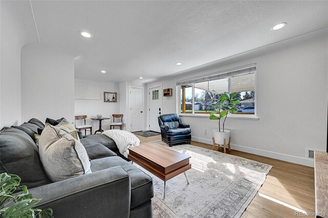 2544 S Raleigh St, Denver, CO 80219 - living room with recessed lighting, visible vents, baseboards, and wood finished floors