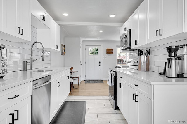2544 S Raleigh St, Denver, CO 80219 - kitchen featuring a sink, light countertops, decorative backsplash, and stainless steel appliances