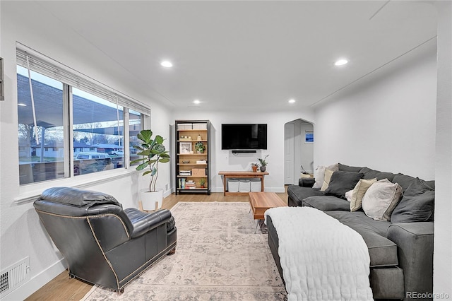 2544 S Raleigh St, Denver, CO 80219 - living area with arched walkways, visible vents, recessed lighting, wood finished floors, and baseboards