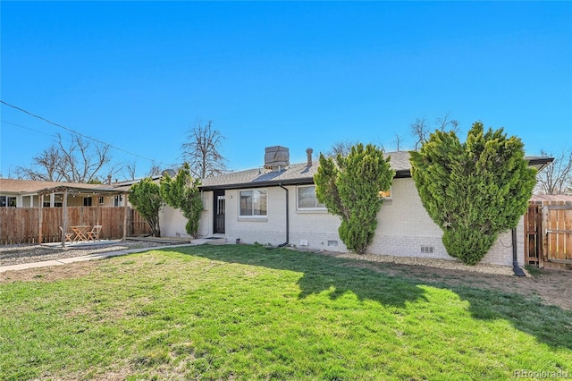 2544 S Raleigh St, Denver, CO 80219 - exterior space with a chimney, fence, brick siding, a front lawn, and roof with shingles