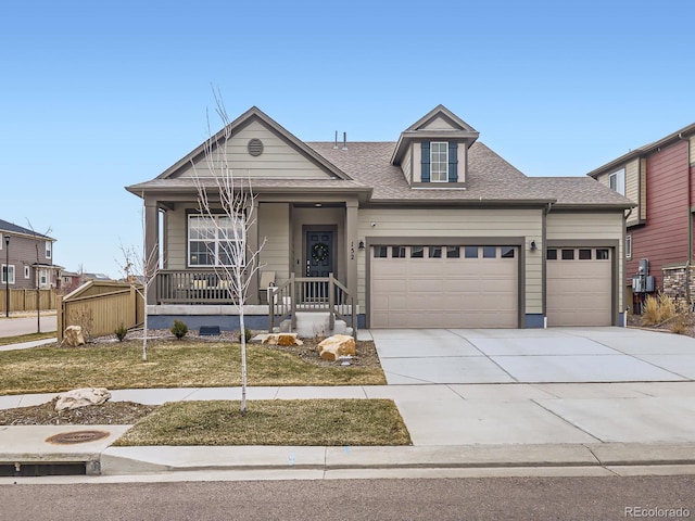 view of front of house featuring a porch, an attached garage, a shingled roof, and driveway