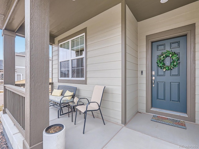 view of exterior entry with a porch