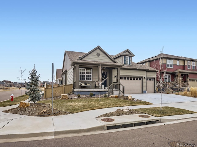 view of front of house with covered porch, an attached garage, and driveway