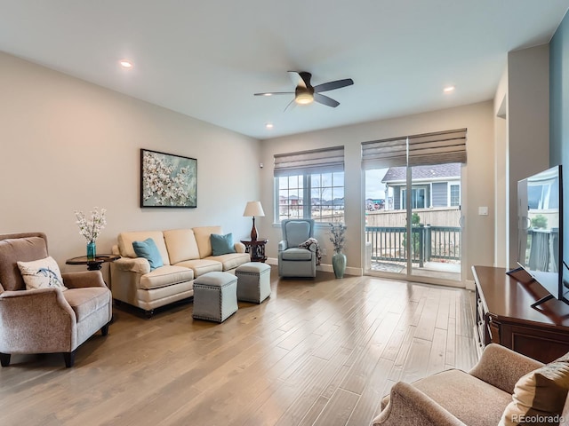 living room featuring recessed lighting, light wood-style flooring, baseboards, and a ceiling fan