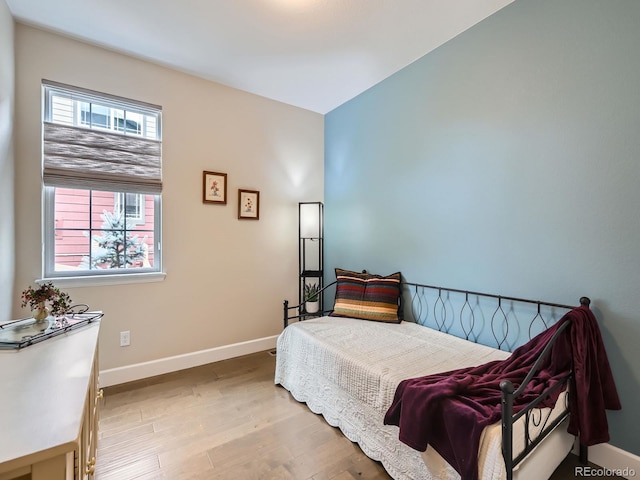 bedroom featuring baseboards and wood finished floors