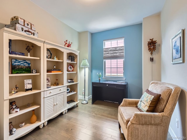 sitting room featuring baseboards and wood-type flooring