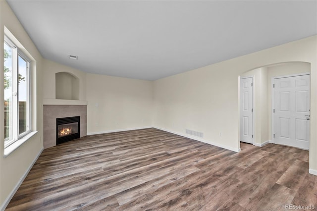 unfurnished living room featuring hardwood / wood-style flooring and a fireplace