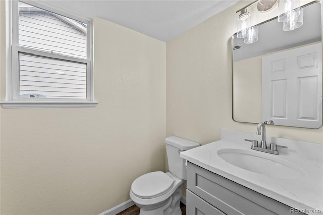 bathroom with toilet and vanity