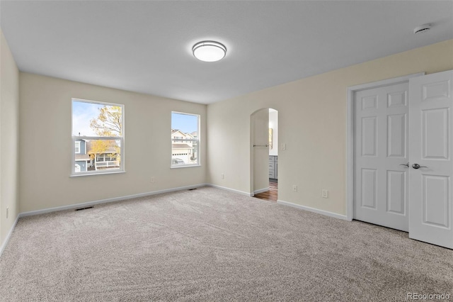 unfurnished bedroom with light colored carpet