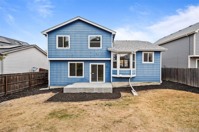 back of house with a patio and a lawn