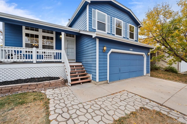 tri-level home with a porch and a garage