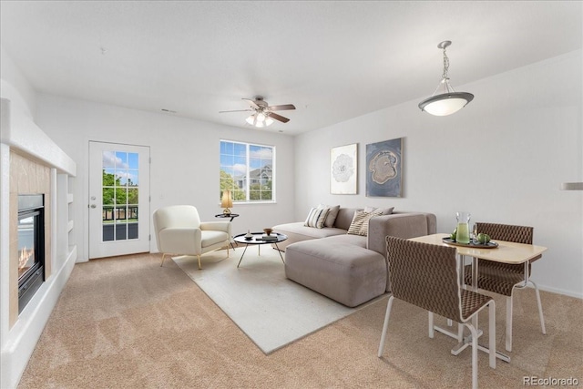 5255 Memphis St Unit 219, Denver, CO 80239 - living room featuring carpet, a ceiling fan, and a glass covered fireplace