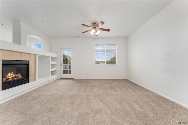 5255 Memphis St Unit 219, Denver, CO 80239 - unfurnished living room featuring a fireplace, light colored carpet, and a ceiling fan