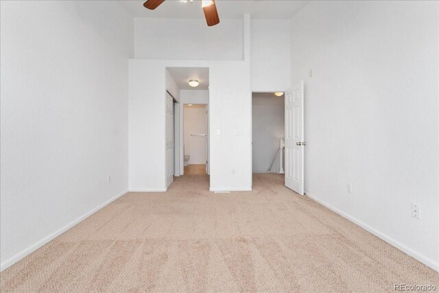 5255 Memphis St Unit 219, Denver, CO 80239 - unfurnished bedroom featuring carpet, ceiling fan, and a towering ceiling