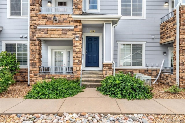 5255 Memphis St Unit 219, Denver, CO 80239 - doorway to property featuring stone siding