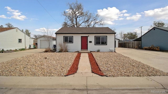 766 Fulton Ave, Brighton, CO 80601 - view of front of property with concrete driveway, an outbuilding, and a garage