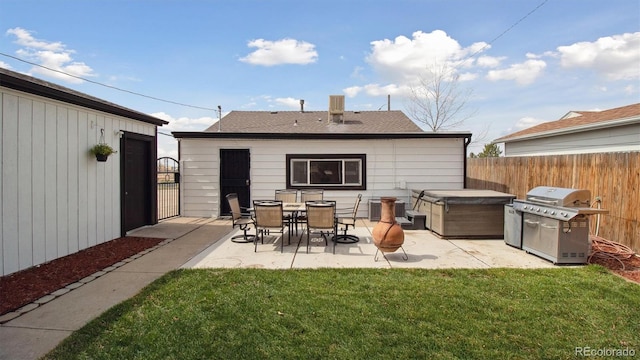 766 Fulton Ave, Brighton, CO 80601 - rear view of house with a patio area, a hot tub, and a shingled roof