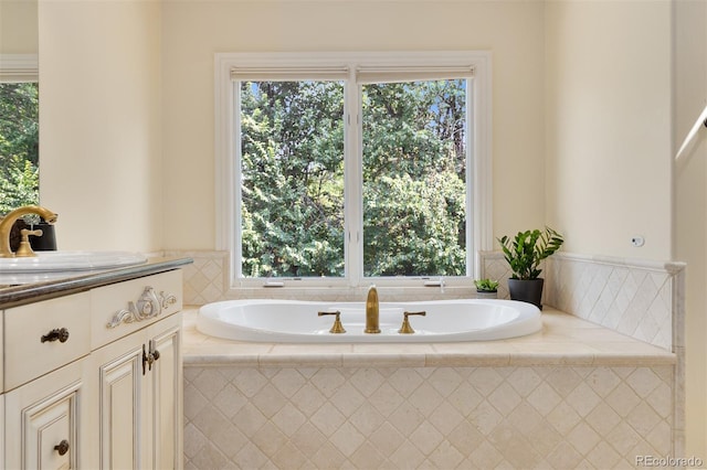 bathroom with sink and a relaxing tiled tub